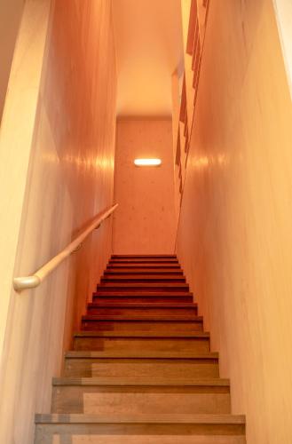 a staircase in a building with a stair case at BEACH AND FIELD INN in Sapporo