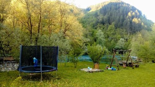 a person standing on a trampoline in a field at Anur House in Bihać