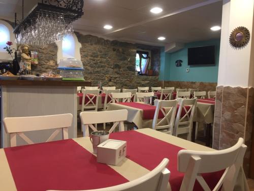 a restaurant with tables and chairs and a bar at Villa Palatina in Bolgues