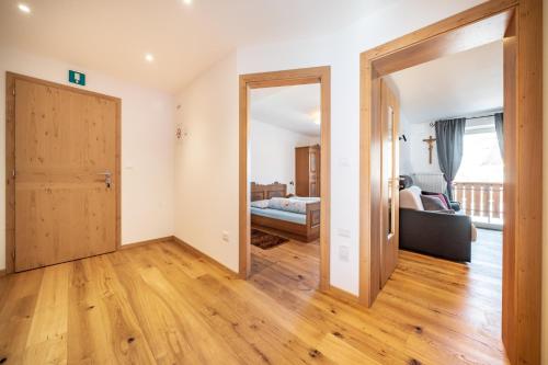 a living room with a door open to a bedroom at Trafisolerhof in Vols am Schlern