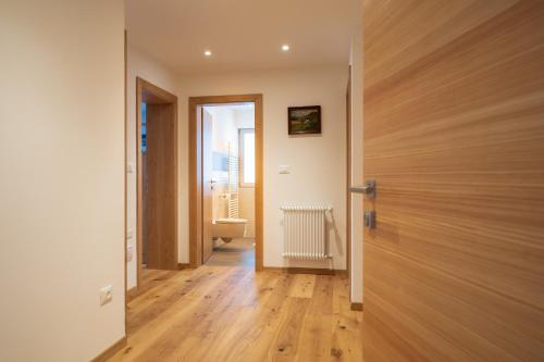 a door leading to a hallway with a bathroom at Trafisolerhof in Vols am Schlern