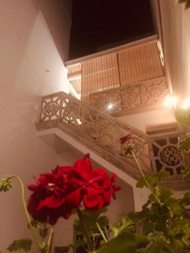 a vase with a red flower next to a balcony at Le Stanze Di Brando E Nico in Tricase