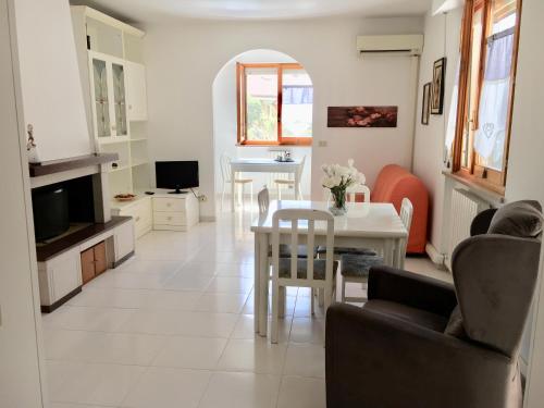 a living room with a table and a dining room at La casa di Lory in Falconara Marittima