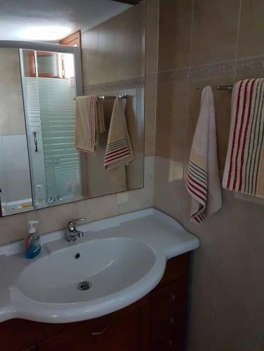 a bathroom with a white sink and a mirror at Holiday Home Dionysis in Chorefto