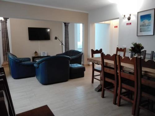 a living room with a couch and a table and chairs at Guesthouse Alentejo in Évora