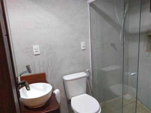 a bathroom with a toilet and a sink and a shower at La Piazzetta di Pipa in Pipa