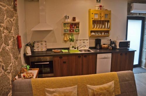 a kitchen with a sink and a counter top at Casa de Campo Sossego da Lata in Fafe