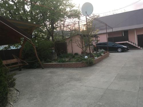 a parking lot with a car parked in a driveway at Приватна садиба Велятин in Velyatyn