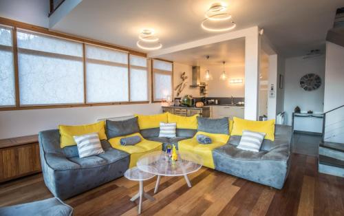 a living room with a couch and a table at The Vaujany Mountain Lodge in Vaujany