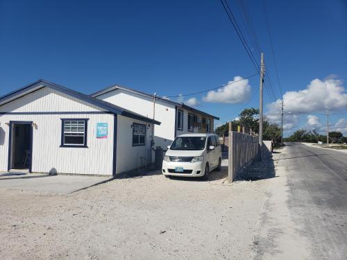 a white car parked in front of a building at Alvira's Place in Mars Bay