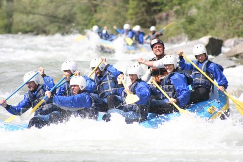 a group of people in a raft on a river at Suite Romantica Fuga in Roncone