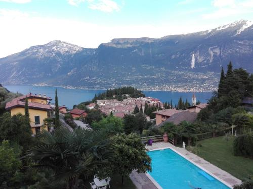 a view of a resort with a swimming pool and mountains at Appartamento Casa Pace Tremosine in Tremosine Sul Garda