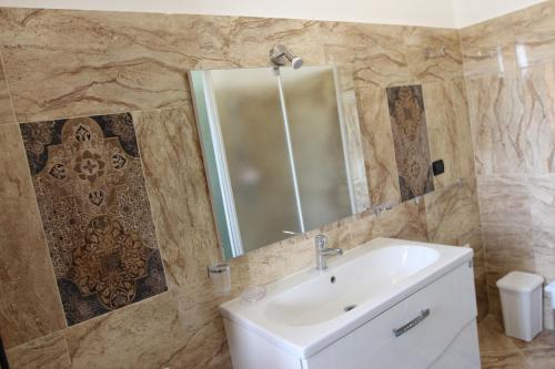 a bathroom with a sink and a mirror at IL FEUDO in Sellia Marina