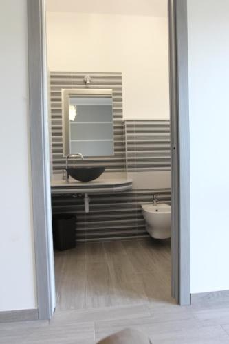 a bathroom with a sink and a mirror at IL FEUDO in Sellia Marina