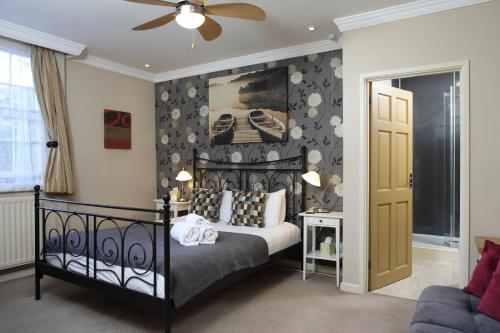 
a bedroom with a bed and a dresser at Eight Bells Inn in Chipping Campden
