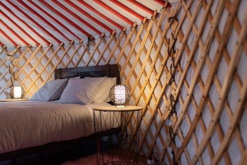 a bedroom with a bed in a yurt at Quinta do Ragal in Lavacolhos