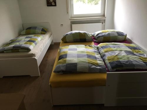 two beds sitting in a room with a window at Riedwiesen in Bad Rappenau