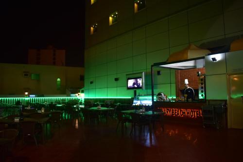 a restaurant with tables and chairs at night at Canary Beach Hotel in Yanbu