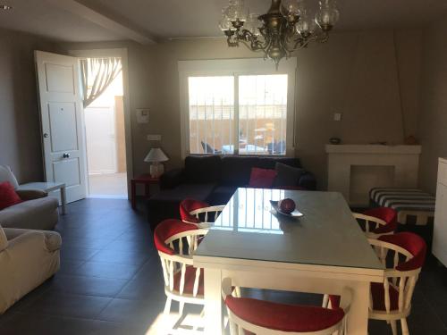 a living room with a table and chairs and a couch at Fercamar Costacabana in Almería