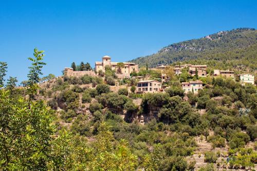 a village on top of a hill with trees at Es Moli Hotel in Deia