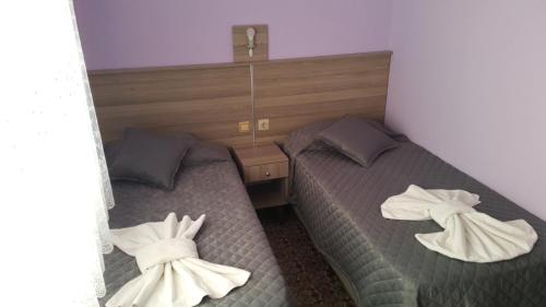 two beds in a bedroom with towels on them at Grand Yayla Hotel in Cesme