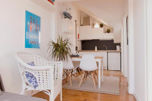a kitchen with a table and chairs in a room at Like Home by Madrabica in Lisbon