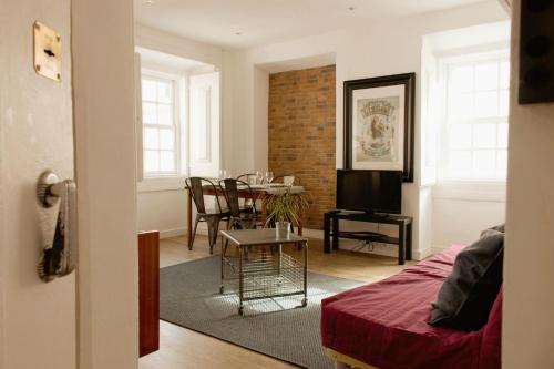 a living room with a table and a dining room at Like Home by Madrabica in Lisbon