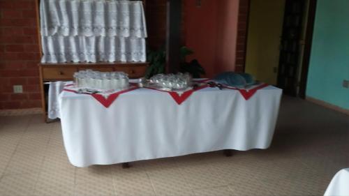 a table with a white table cloth on it at Pousada Boramar in Boracéia