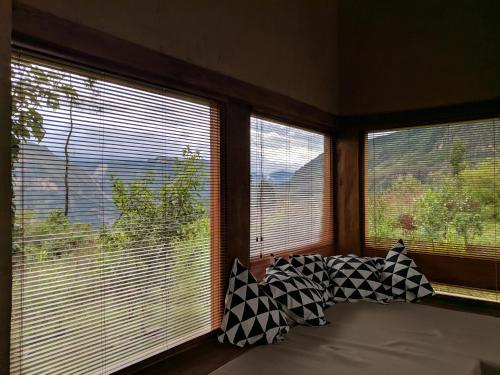 a room with two windows with pillows in front of them at Mamaq Tambo Lodge in Cocachimba