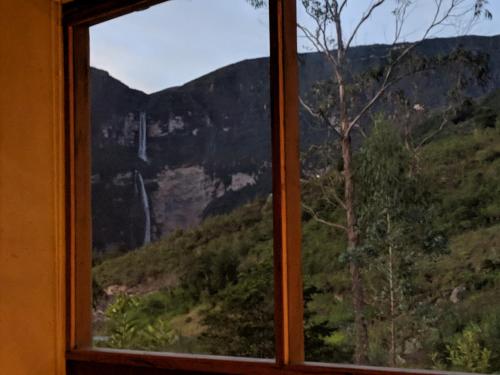 a window with a view of a mountain at Mamaq Tambo Lodge in Cocachimba