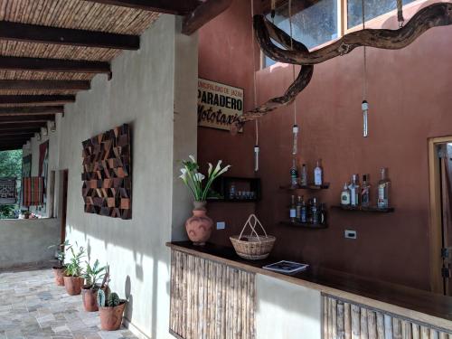 a bar in a building with plants on the wall at Mamaq Tambo Lodge in Cocachimba