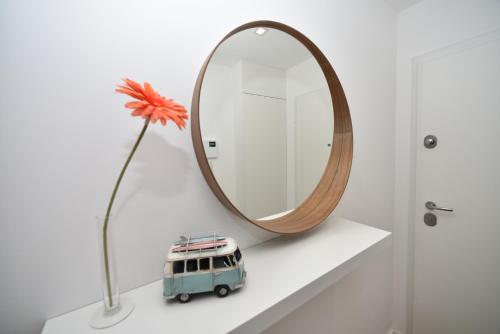 a toy van sitting on a shelf next to a mirror at Xenon Urban Apartments in Maputo