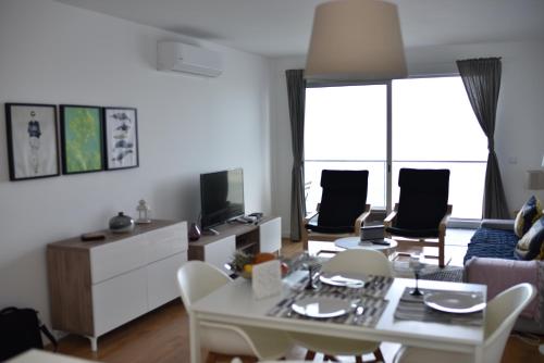 a living room with a table and chairs at Xenon Urban Apartments in Maputo