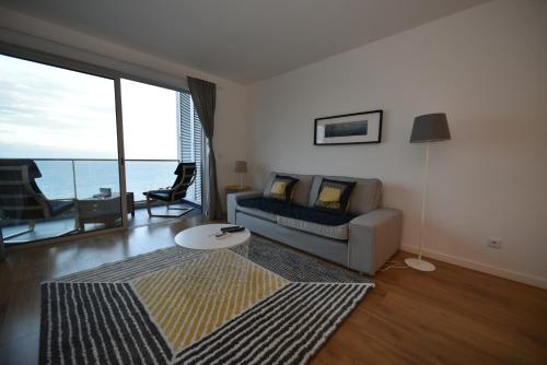 a living room with a couch and a table at Xenon Urban Apartments in Maputo