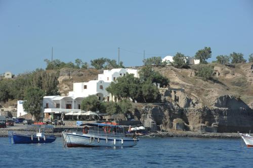 a group of boats in the water near a beach at Akrotiri Hotel in Akrotiri