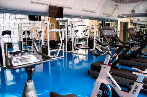 a gym with treadmills and elliptical machines at Hotel Mirage - Centro Histórico de Querétaro in Querétaro