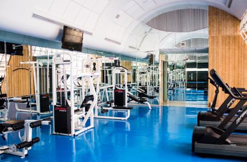 a gym with blue flooring and tread machines at Hotel Mirage - Centro Histórico de Querétaro in Querétaro