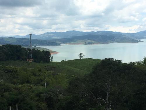 a view of a large body of water with a tree at La cabaña del lago Calima in Calima