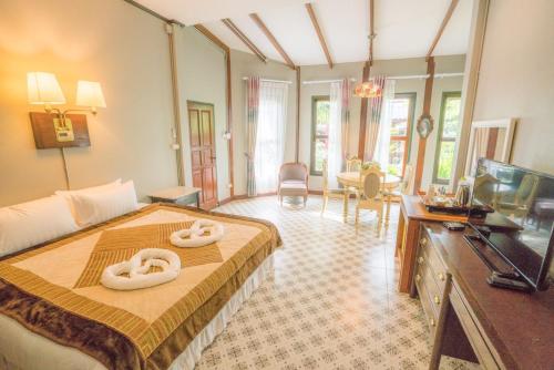 a bedroom with a bed with two swans on it at Ban Mai Vintage in Pak Chong