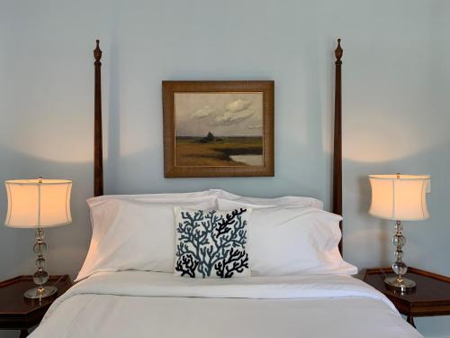 a bedroom with a white bed with two lamps at The Oak Bluffs Inn in Oak Bluffs