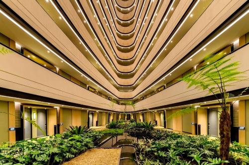 an office building with a lobby with plants at Grand Hyatt Bogota in Bogotá