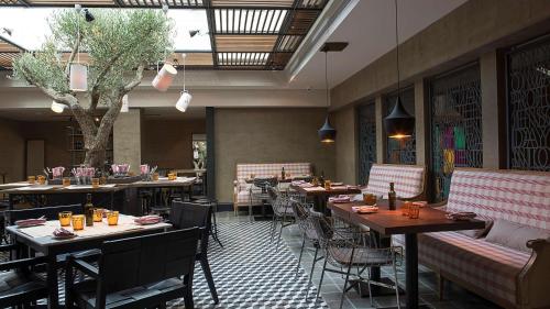 a restaurant with tables and chairs in a room at Hyatt Centric Montevideo in Montevideo