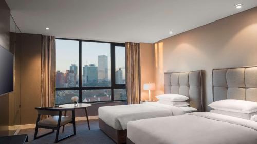 a hotel room with two beds and a large window at Hyatt Centric Montevideo in Montevideo