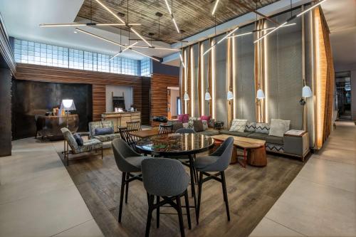 a living room with a table and chairs at Hyatt Herald Square New York in New York