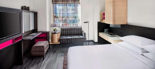 a hotel room with a bed and a television at Hyatt Herald Square New York in New York