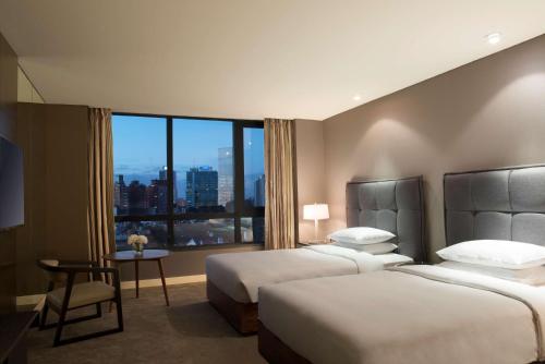 a hotel room with two beds and a window at Hyatt Centric Montevideo in Montevideo