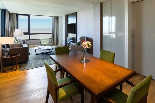 a living room with a wooden table and chairs at Hyatt Centric Montevideo in Montevideo