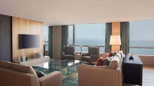 a living room with a couch and a tv at Hyatt Centric Montevideo in Montevideo