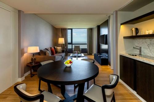 a living room with a table and chairs in a room at Hyatt Centric Montevideo in Montevideo