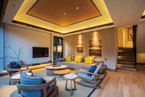 a living room with a couch and chairs and a tv at AHN LAN Ninghai in Ninghai